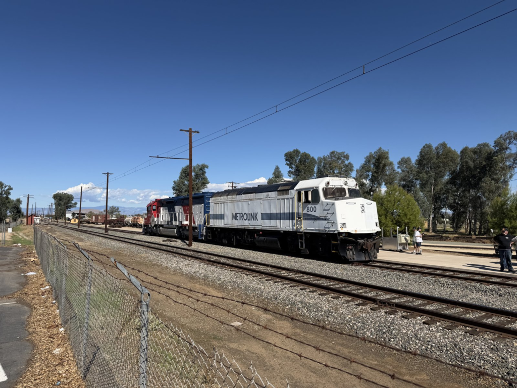 Wide side view of Metrolink No. 800 with other equipment coupled behind, October 24, 2026, at the Southern California Railway Museum